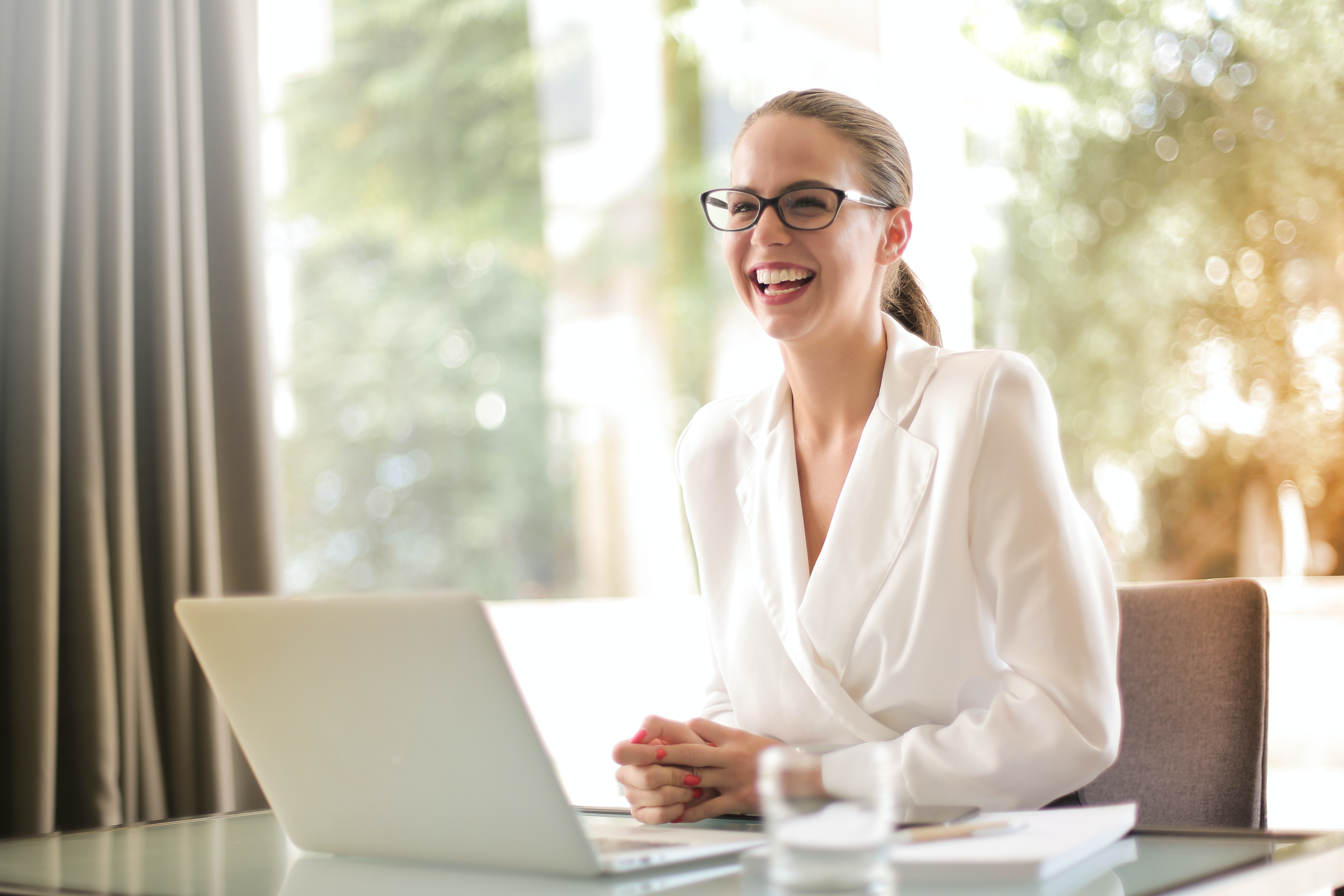 laughing businesswoman working in office with laptop 3756679